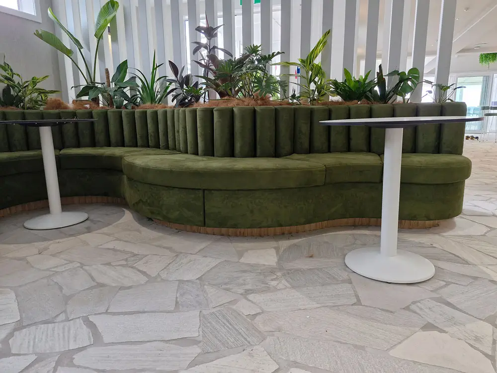 Interior of cocktail Bar with custom squab seating and round tables frontal view