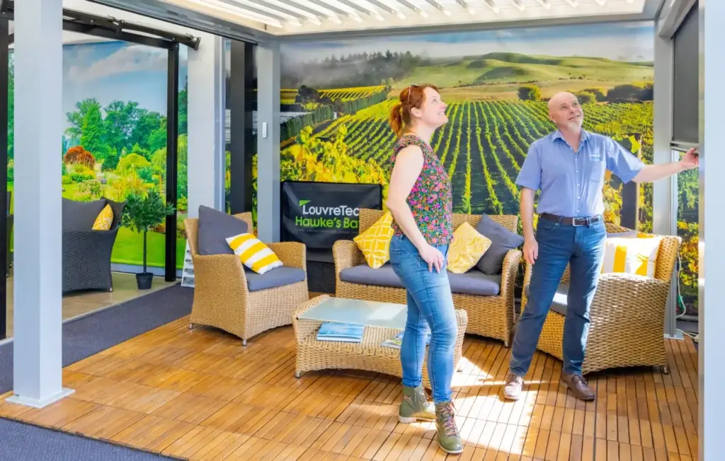 A customer exploring the Louvretec range of outdoor roofs, blinds and patio enclosures in the Douglas Showroom, Queen St West, Hastings, Hawkes Bay