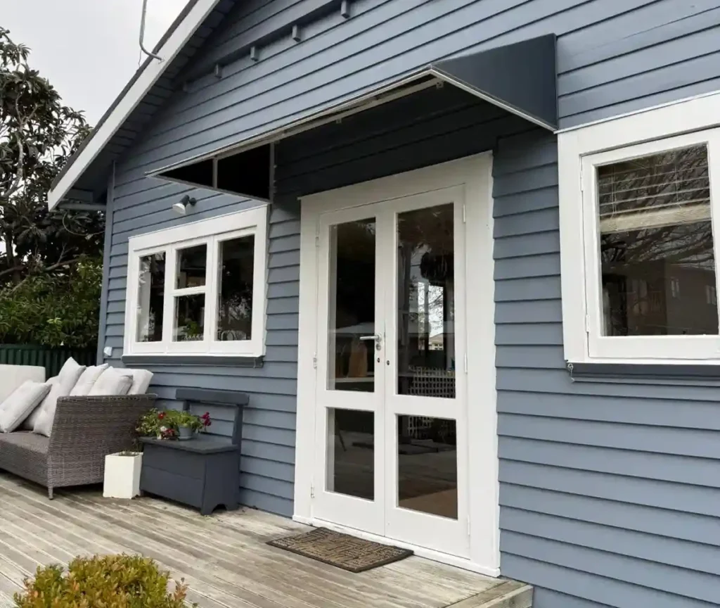 Custom door awning on a Hastings villa, providing stylish front door weather protection by Douglas Innovation
